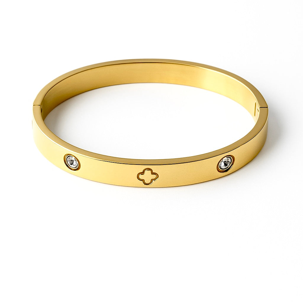 Gold bracelet with diamond accents on a white background