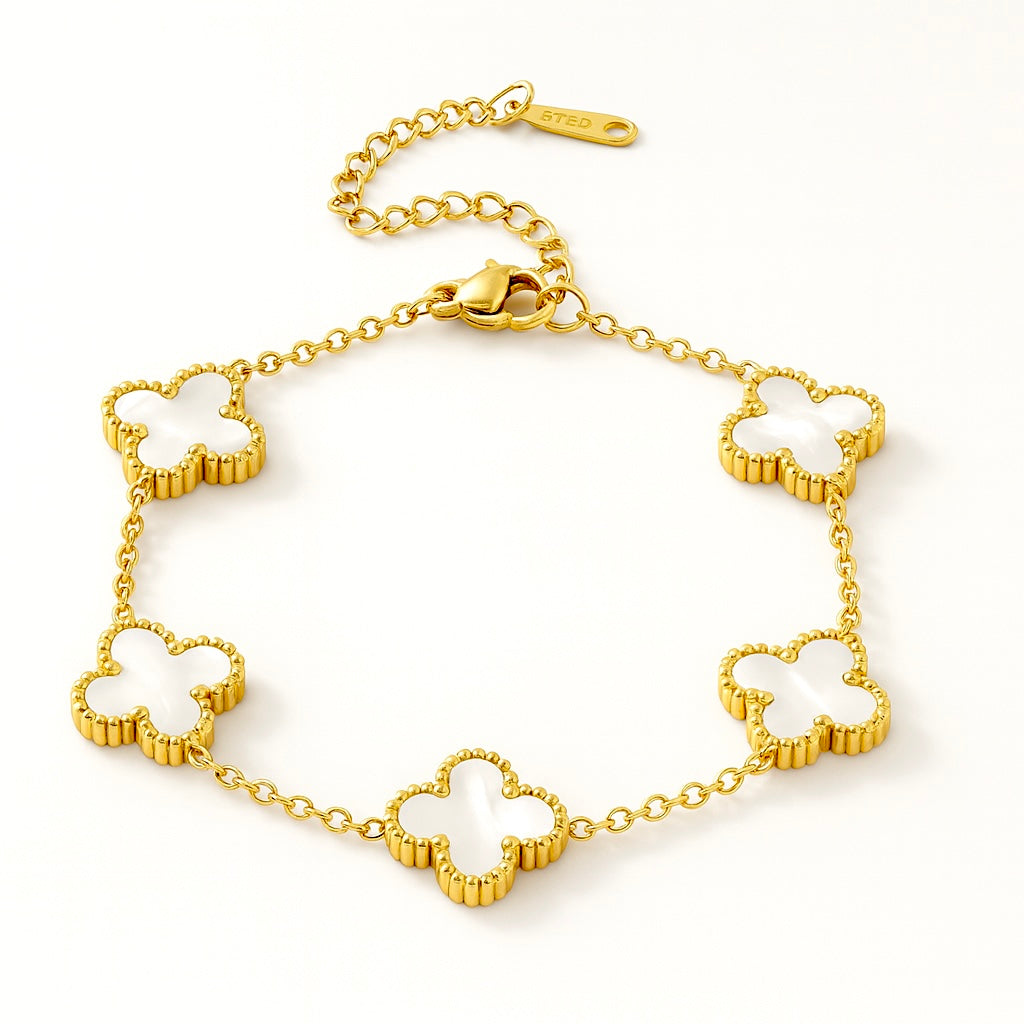 Gold bracelet with clover-shaped links on a white background