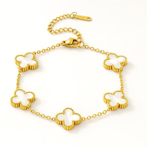 Gold bracelet with clover-shaped links on a white background