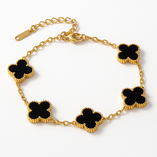 Gold bracelet with black clover-shaped charms on a white background